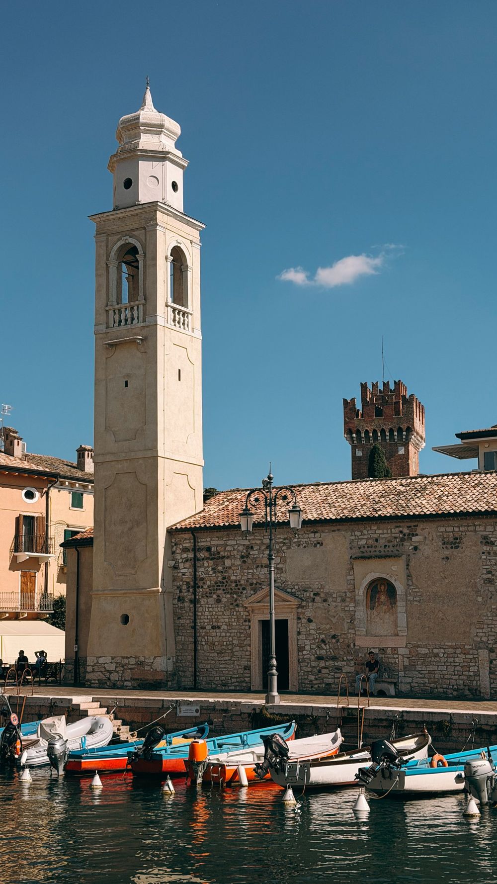 Bell tower and boats in the harbour of Lazise