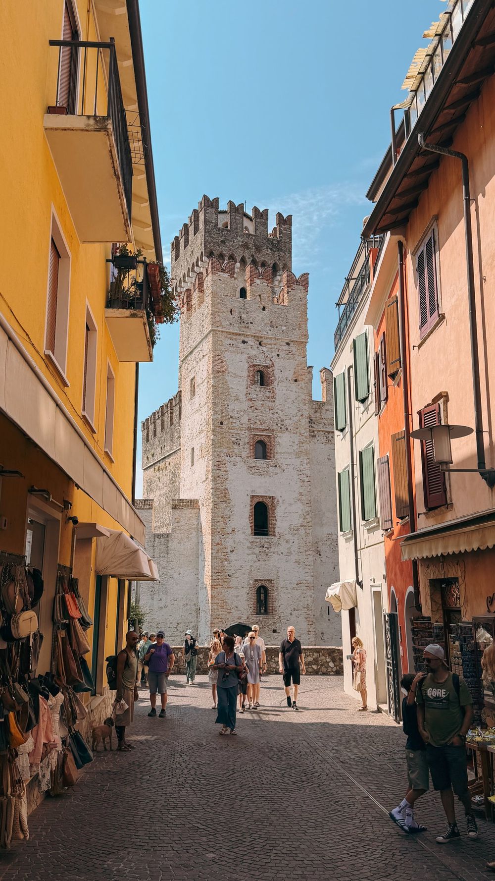 A street of colourful houses leading to the castle tower