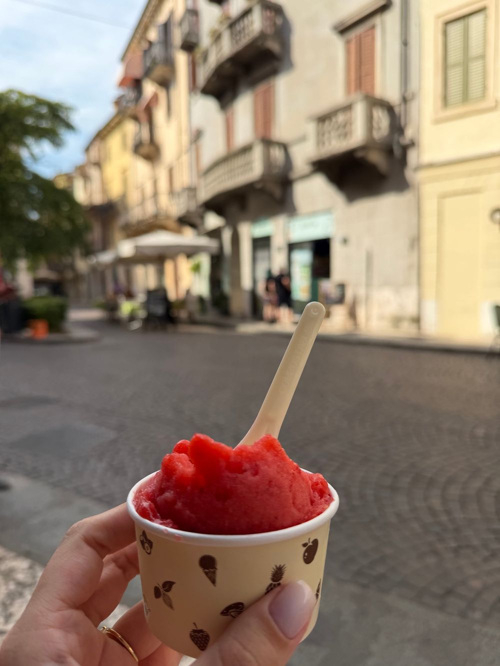 A cup of red sorbet in a Verona street